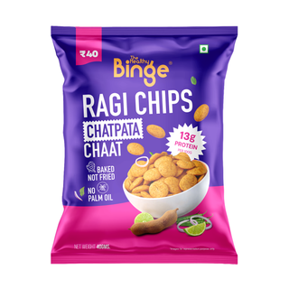 A bag of The Healthy Binge Ragi Chips Chatpata Chaat in a purple and pink package, featuring a bowl of golden-brown chips and lime slices on the front.
