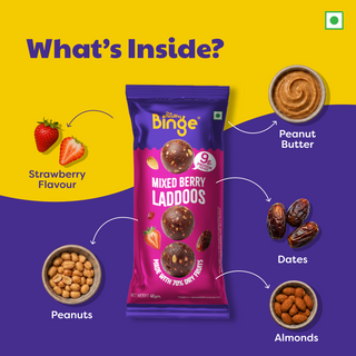 A promotional product graphic for a bag of THB's Mixed Berry Laddoos. The central subject is the purple and pink snack bag, surrounded by callout arrows and ingredient labels pointing to strawberry-flavour ingredients: peanut butter, dates, peanuts, and almonds.