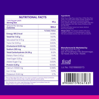 The back of a packaged food product on a solid purple background, displaying a white Nutrition Facts label with nutritional information, ingredients list, manufacturer details, and a barcode.